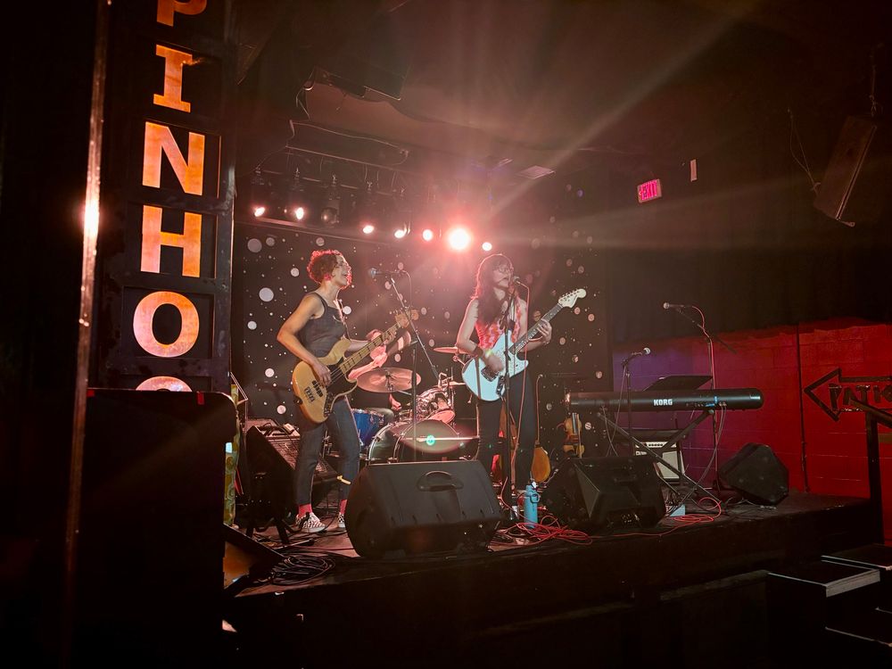 lalitree darnielle performing at the pinhook in durham, nc alongside a bassist and drummer