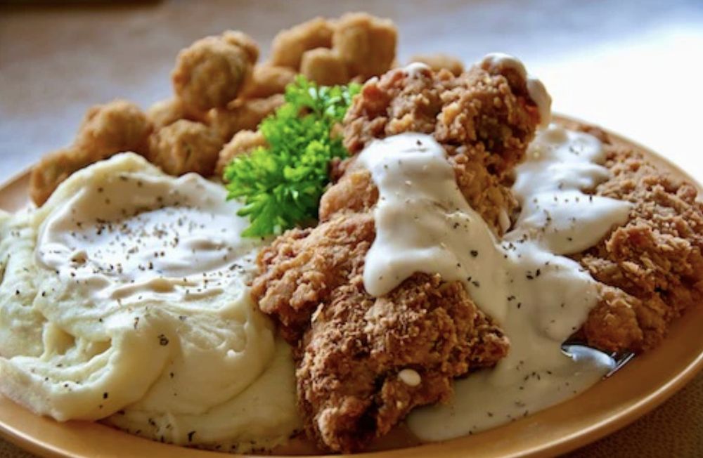 Chicken fried steak, mashed potatoes, gravy and fried okra.