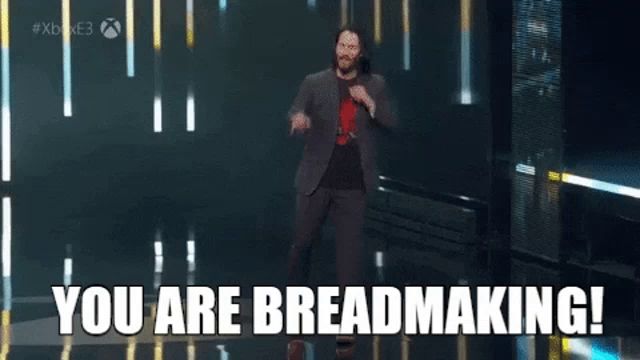 a man in a suit is dancing on a stage with the words you are breadmaking behind him