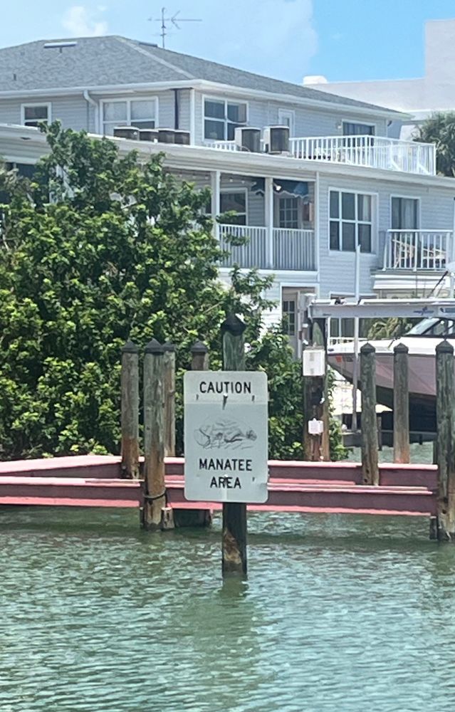Sign in water stating ‘caution - manatee area’