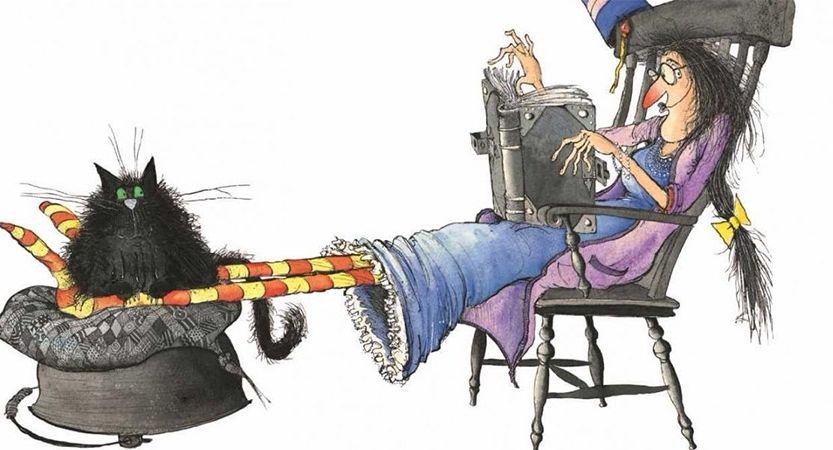 Winnie the Witch did in a chair with her feet up reading a heavy spellbook. Fat, black cat Wilbur sits on her stripey, socked feet. 