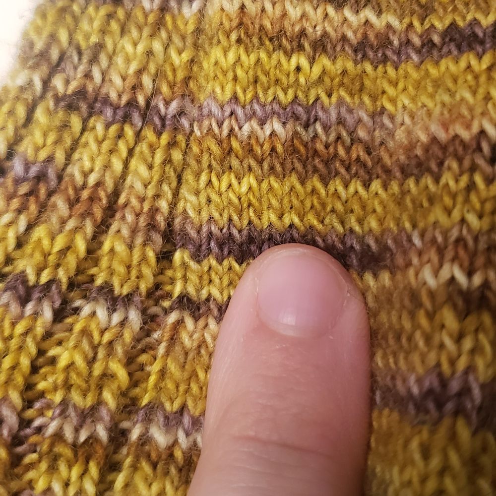 Finger for scale: it takes about six tiny stitches to equal the width of my finger
