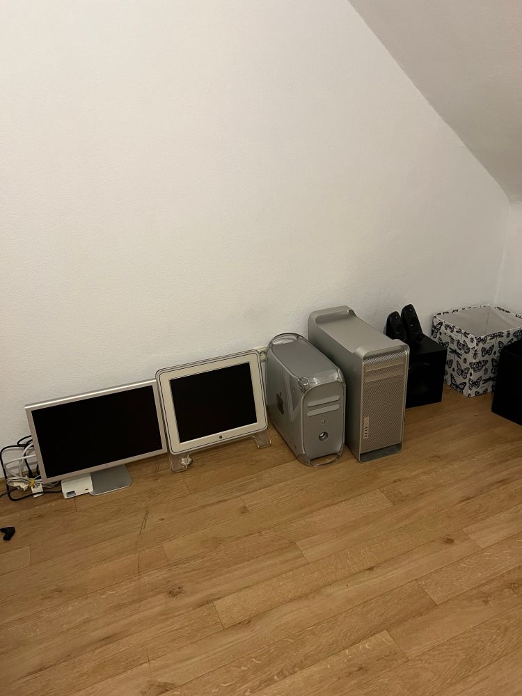 A bunch of apple monitors and computers