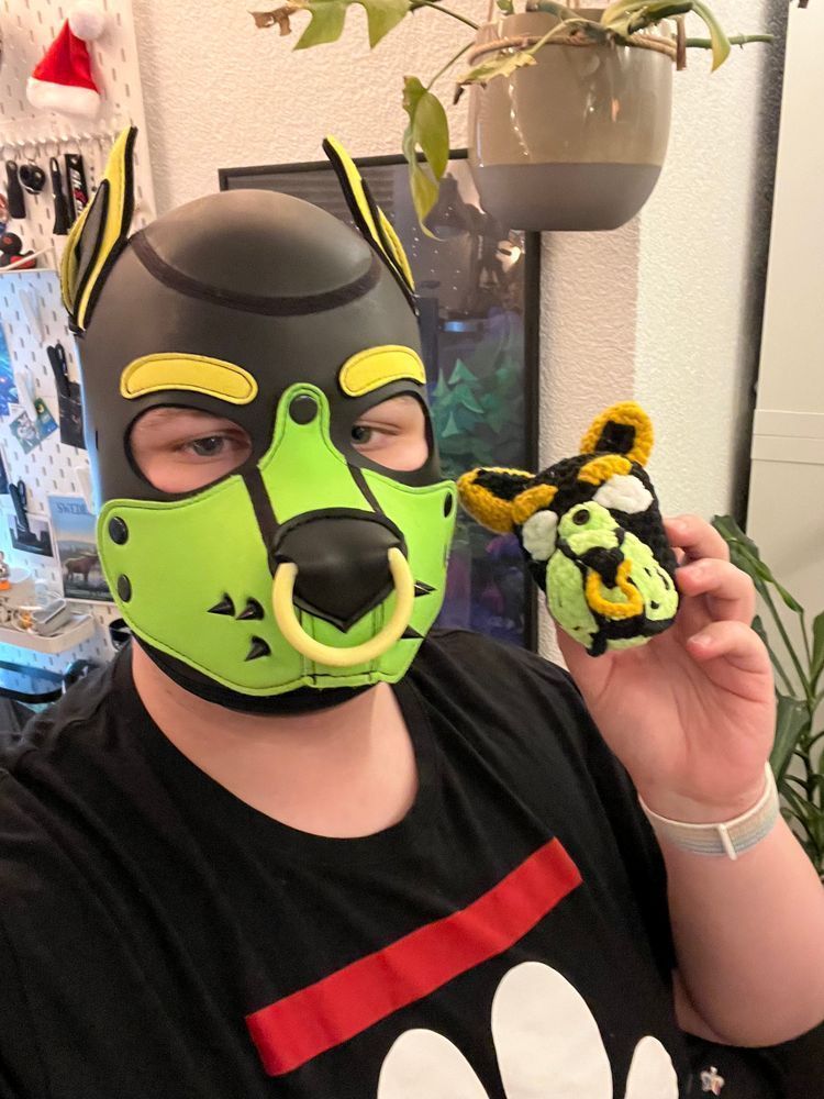 Artemis holding up a knitted replica of himself