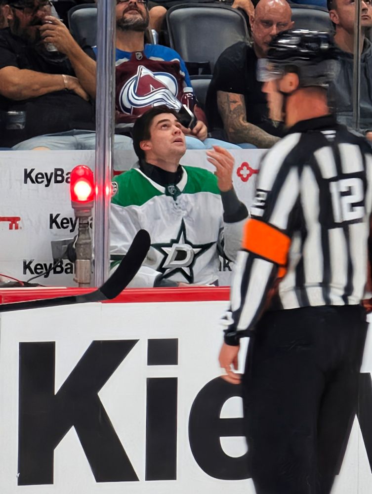 Lian Bichsel sits in a penalty box, looking frustrated. 