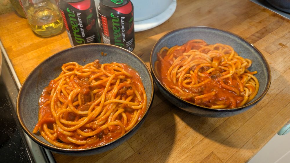 2 bowls of Bucatini all’Amatriciana and two cans of Green sour cherry drink.