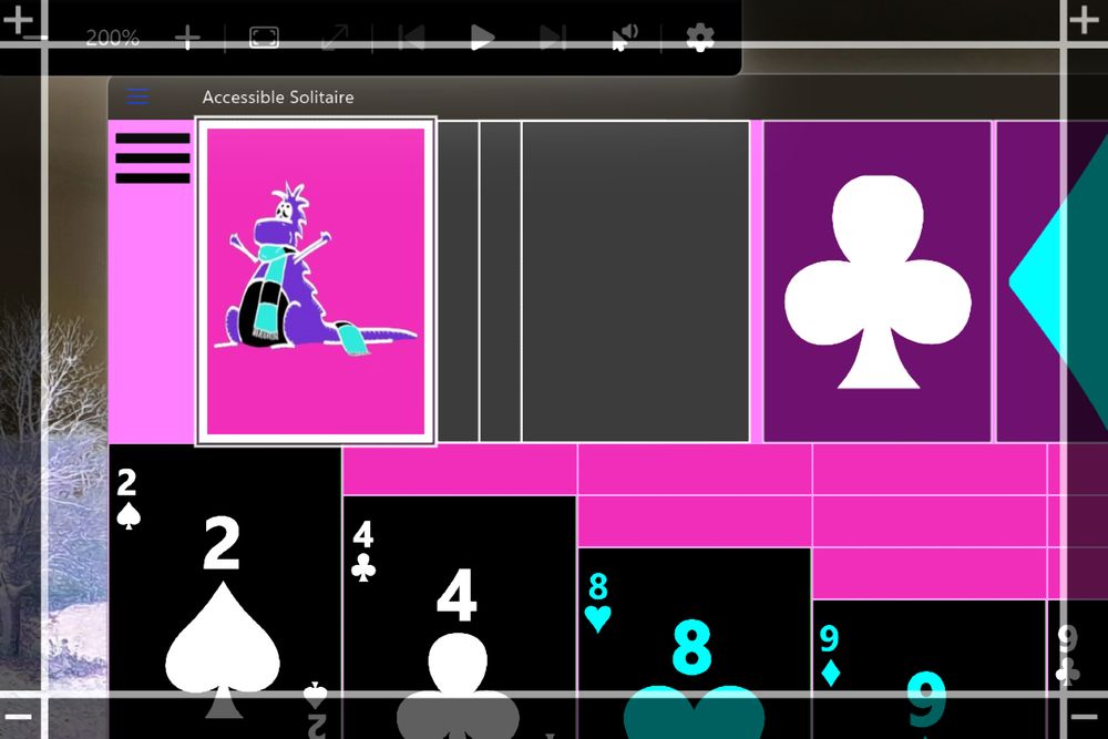 Windows Magnifier magnifying the top left portion of the Accessible Solitaire app. The Magnifier's invert colours setting is on.