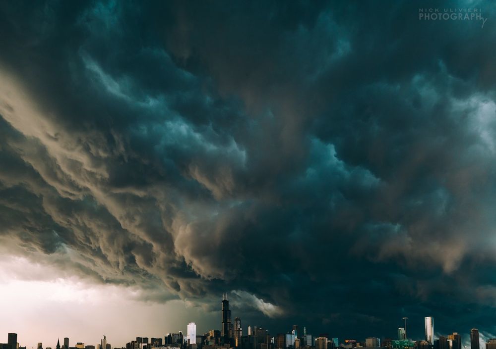 The Chicgago skyline at the bottom of the frame is dwarfed by a massive, roiling shelf cloud