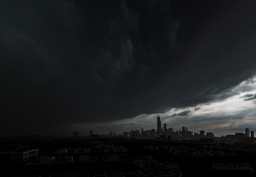 A very moody scene of an intense thunderstorm moving through Chicago. The skyline is small and distant while a massive, dark shelf cloud takes over the sky. This is from a derecho that plowed across the Midwest on August 10, 2020