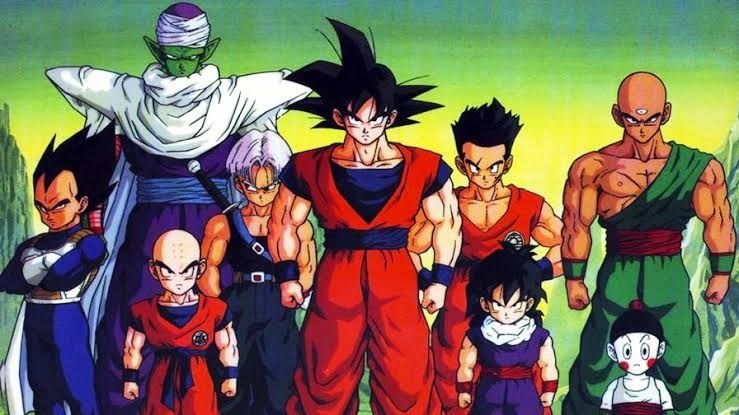 Imagem comercial de dragon ball z, com goku bo centro, yamcha, gohan, caos e tenshin han a direita, e com trunks crescido, kuririn, piccolo e vegeta a esquerda