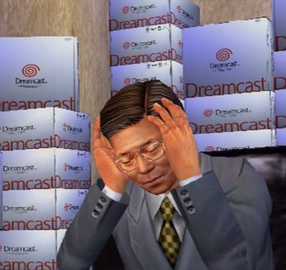 3D render of japanese salary man holding his head in his hands in front of stacks of Dreamcast boxes