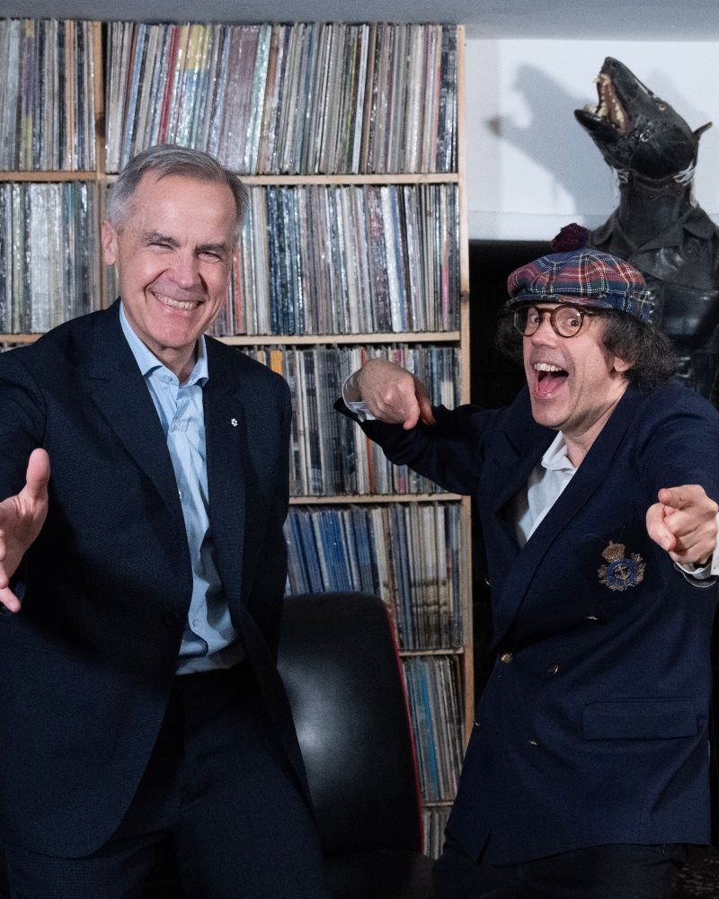Mark Carney poses for a photo with Nardwuar during an interview in Vancouver, British Columbia. 