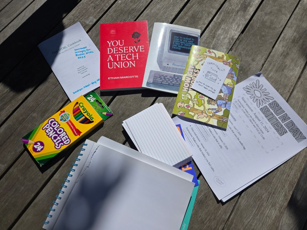 zines and art supplies on a picnic table