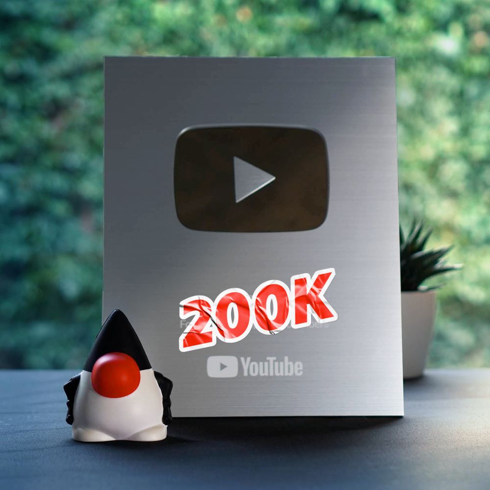 Youtube plaque with 200K and the Duke Java mascot squishy toy next to it.