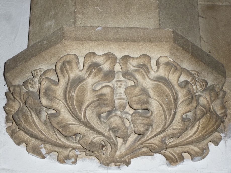 Stone corbel, with acorns in the middle of large swirling oak leaves