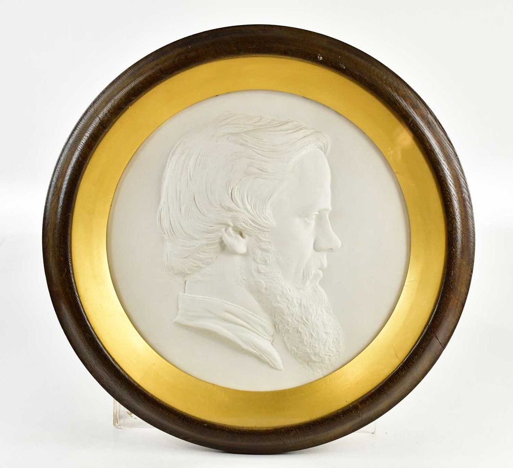 Profile bas-relief of the artist with wavy hair and bushy but neat beard, in an attractive circular gilt-rimmed and dark wood frame