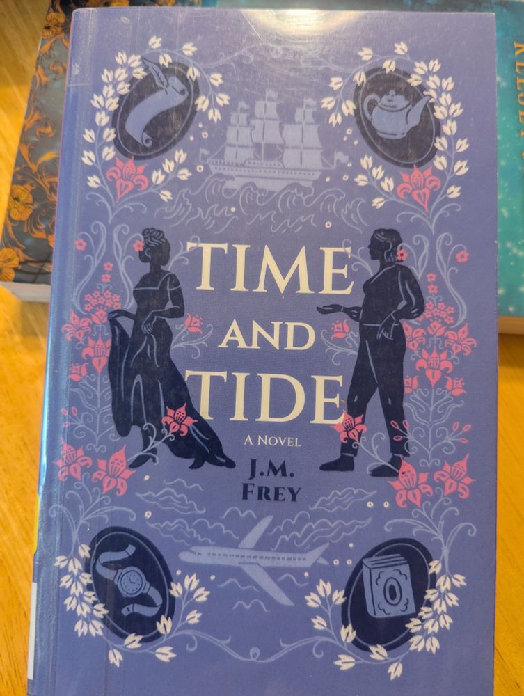 Time and Tide by J.M. Frey. The cover is lavender with the silhouettes of two women, one in Georgian era clothing and the other in a shirt and trousers. A paper and quill, sail ship, teapot, book, airplane, and watch are around the edges. Purple, white, and pink flowers are around the cover, as well.