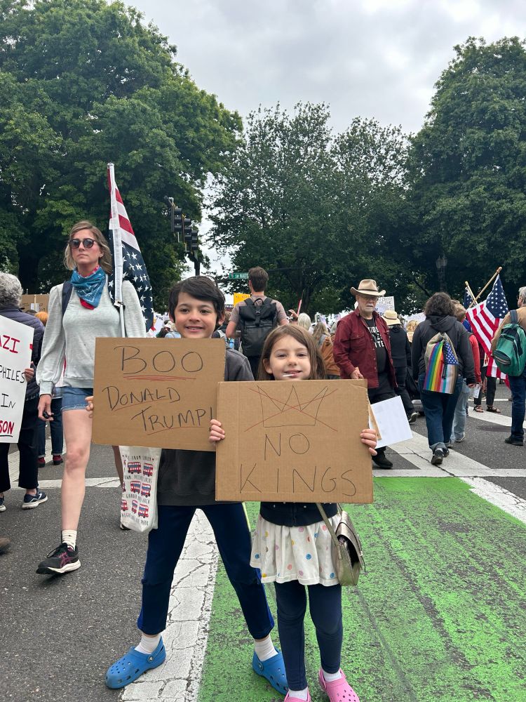 Two children holding signs at rally