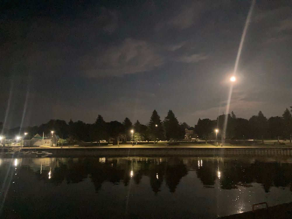 The moon alights a dark bay.