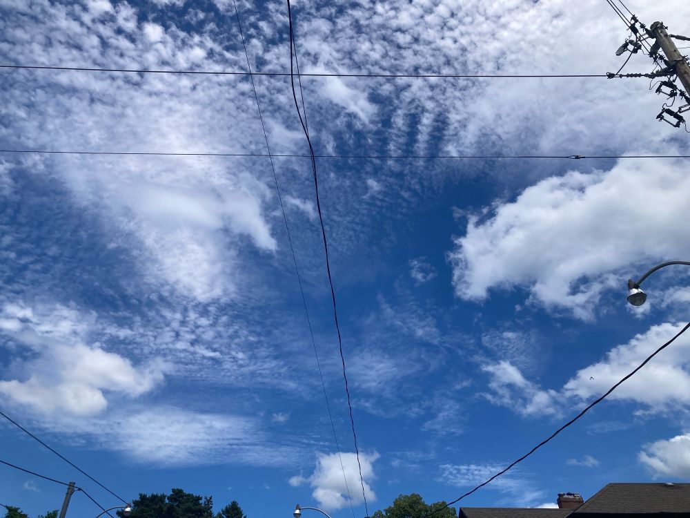 Cloud formation on a clear day. It appears as though there is a giant handprint in the clouds.