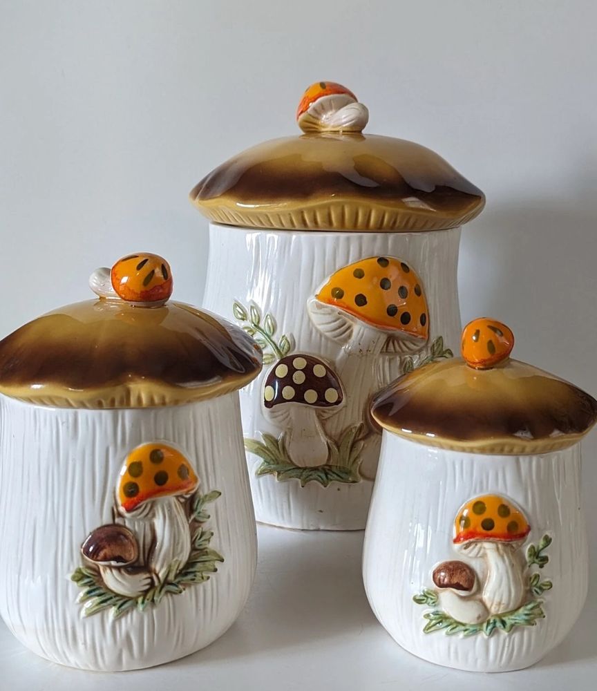 Antique merry mushroom canisters depicting orange and brown mushrooms.