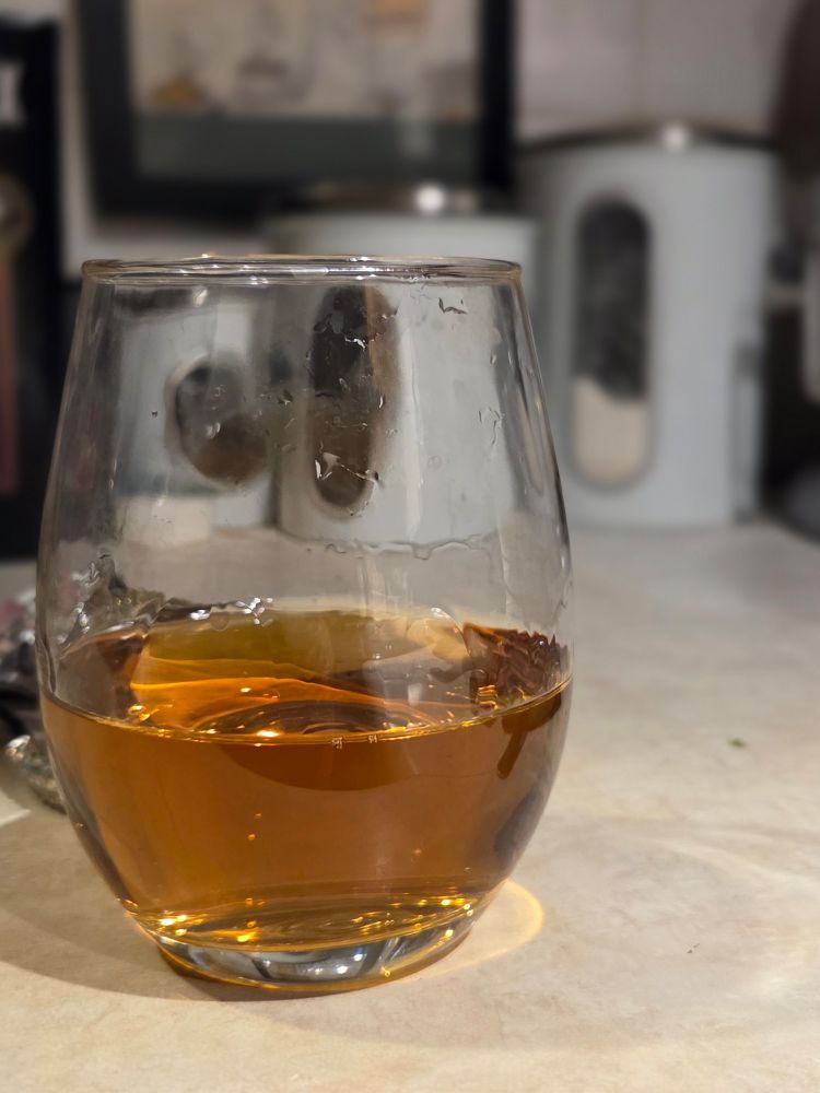 Golden mead in a stemless wine glass