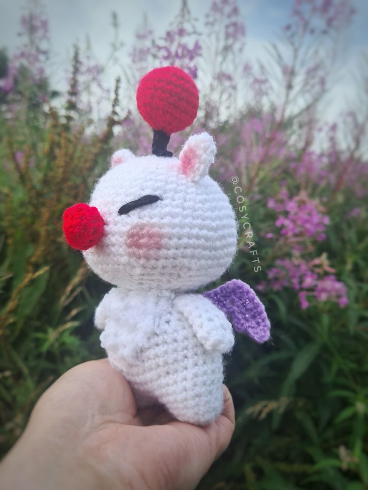 Side view of the same crochet moogle from the main post but showing the wings clearer 