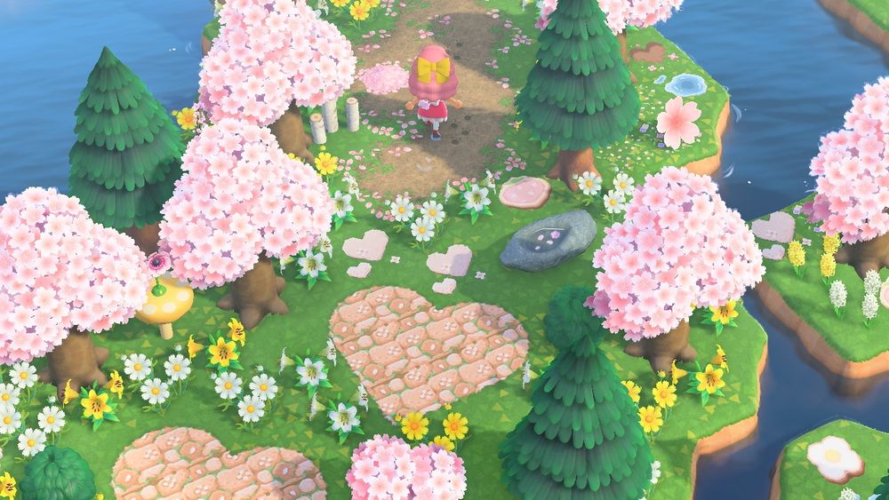 An Animal Crossing New Horizons island screenshot with heart paths and pink trees.