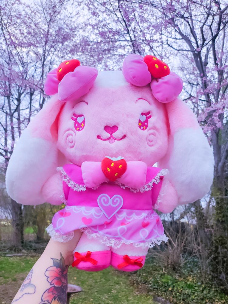 a pink lop bunny plush with a detailed strawberry dress