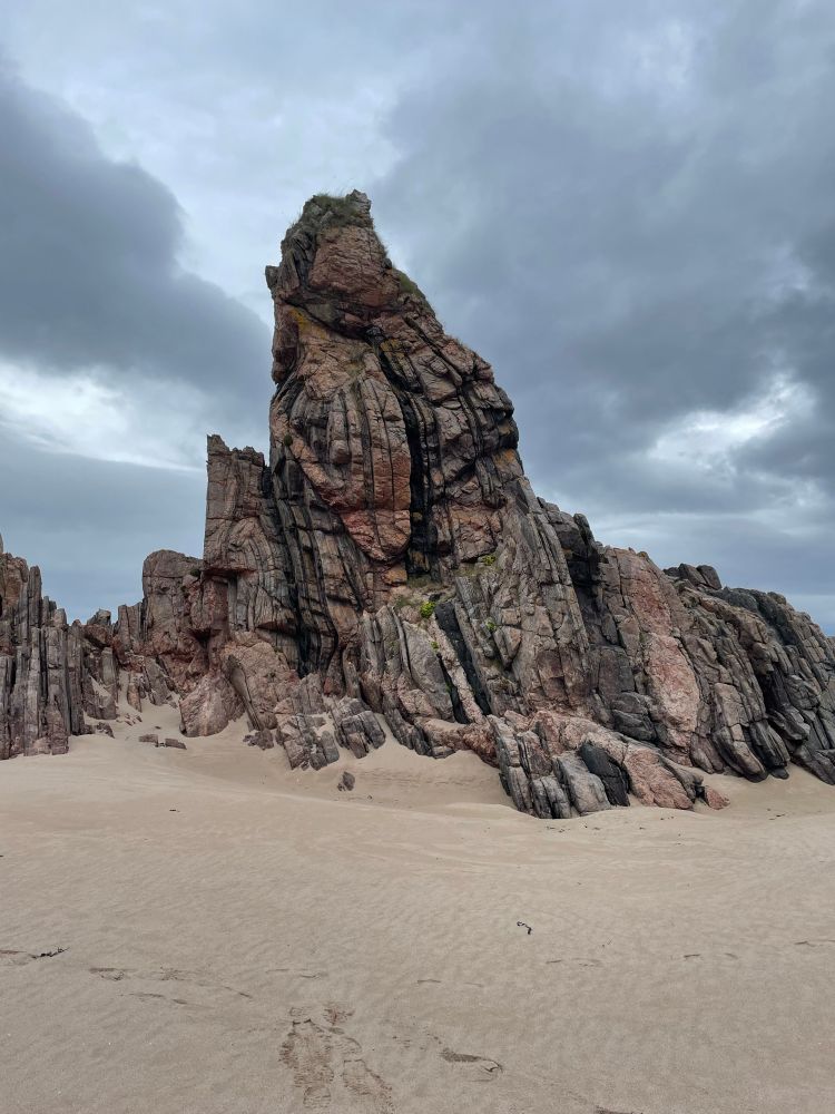 Jagged rocks on a sandy beach in the far north of Scotland 