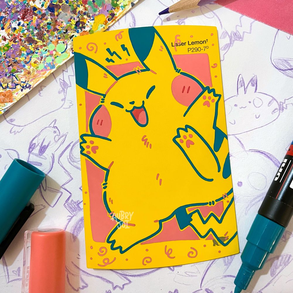 A paint pen illustration on a yellow paint swatch card of Pikachu. They are raising their arms and one of their feet, mouth open, looking joyous. Pikachu is colored by the swatch card (a bright yellow) and they have dark teal outlines with red-pink cheeks. The painting is laying over an open sketch page of other Pikachus. 