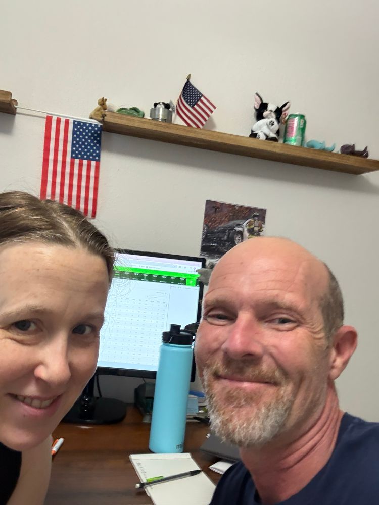 Jake & Laura at a desk in front of a computer screen waiting for the draft to begin