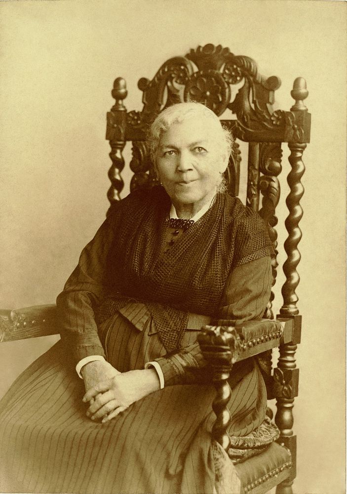 1894 photo of Harriet Jacobs, around age 80, in ornate wooden chair.
