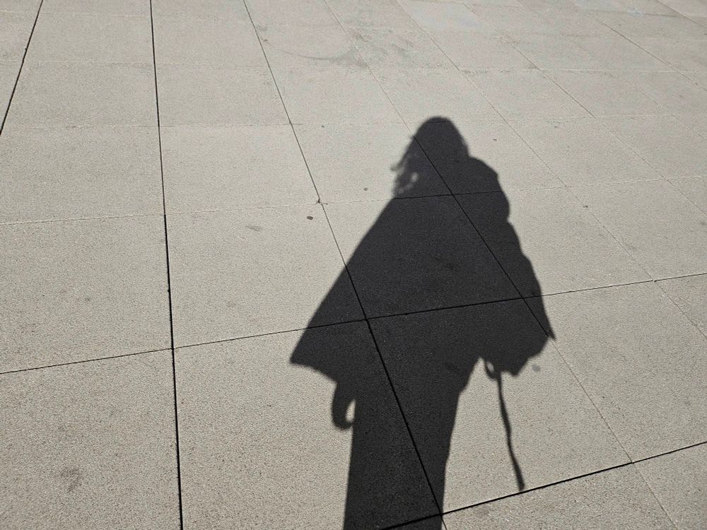 my shadow on tiled concrete