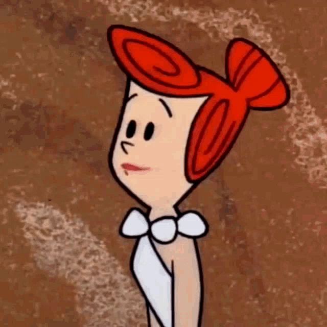 a cartoon character with red hair and a bow tie is standing on a brown background .