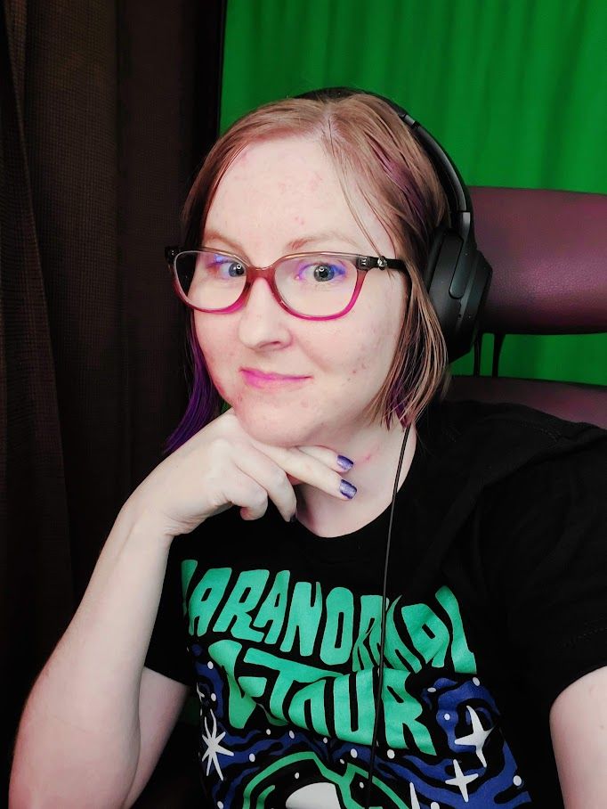 Just a selfie of me in front of my green screen, wearing a black T-shirt with blue-green lettering printed on it