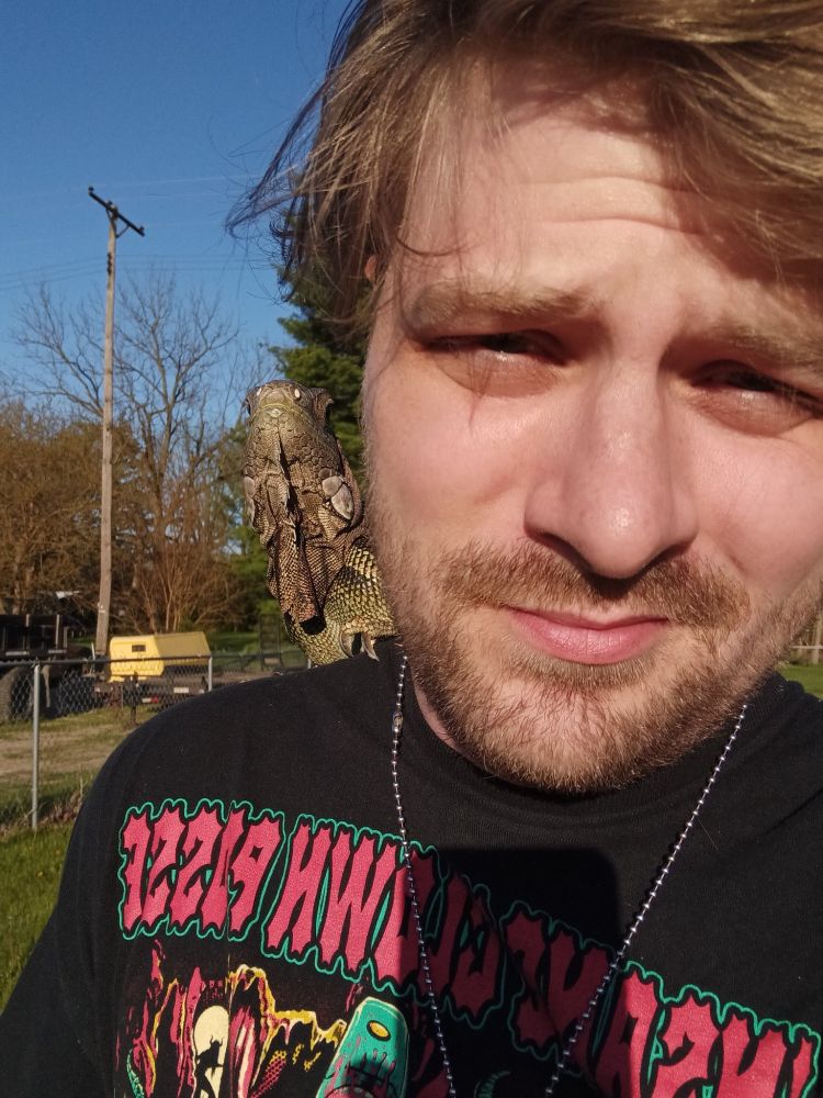 a man with a lizard on his shoulder