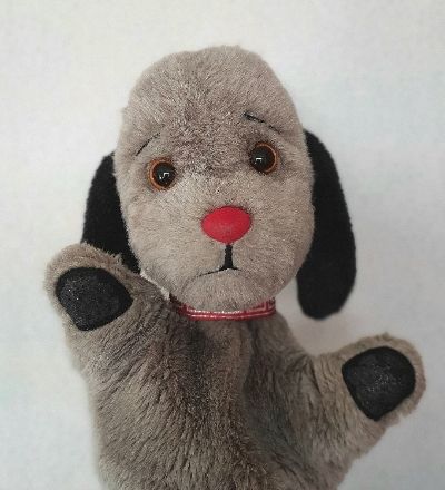 A picture of Sweep the Puppet with his arms open wide

