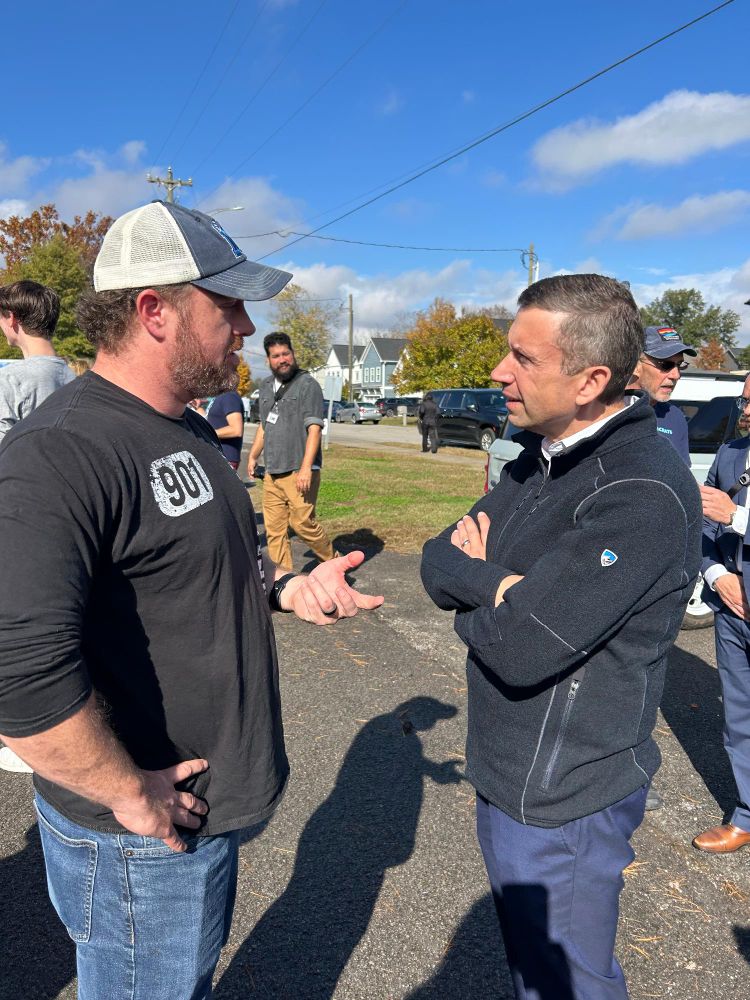Photo of DNC Chair Ken Martin talking with a voter at the Aftyn event.