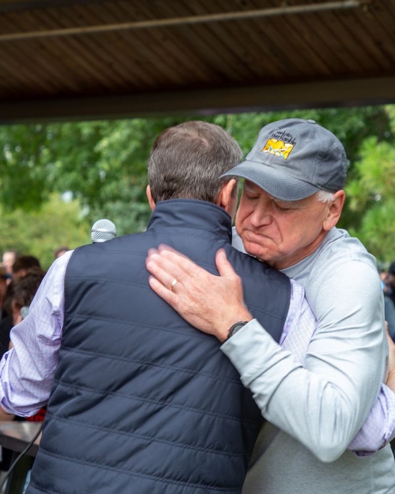 DNC Chair Ken Martin embracing Governor Tim Walz during a reception event at the Minnesota State Fair.