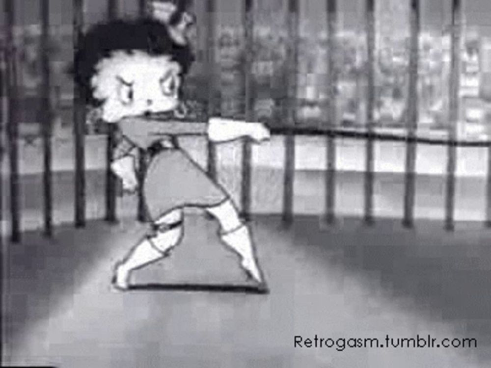 a black and white photo of betty boop dancing in a cage .