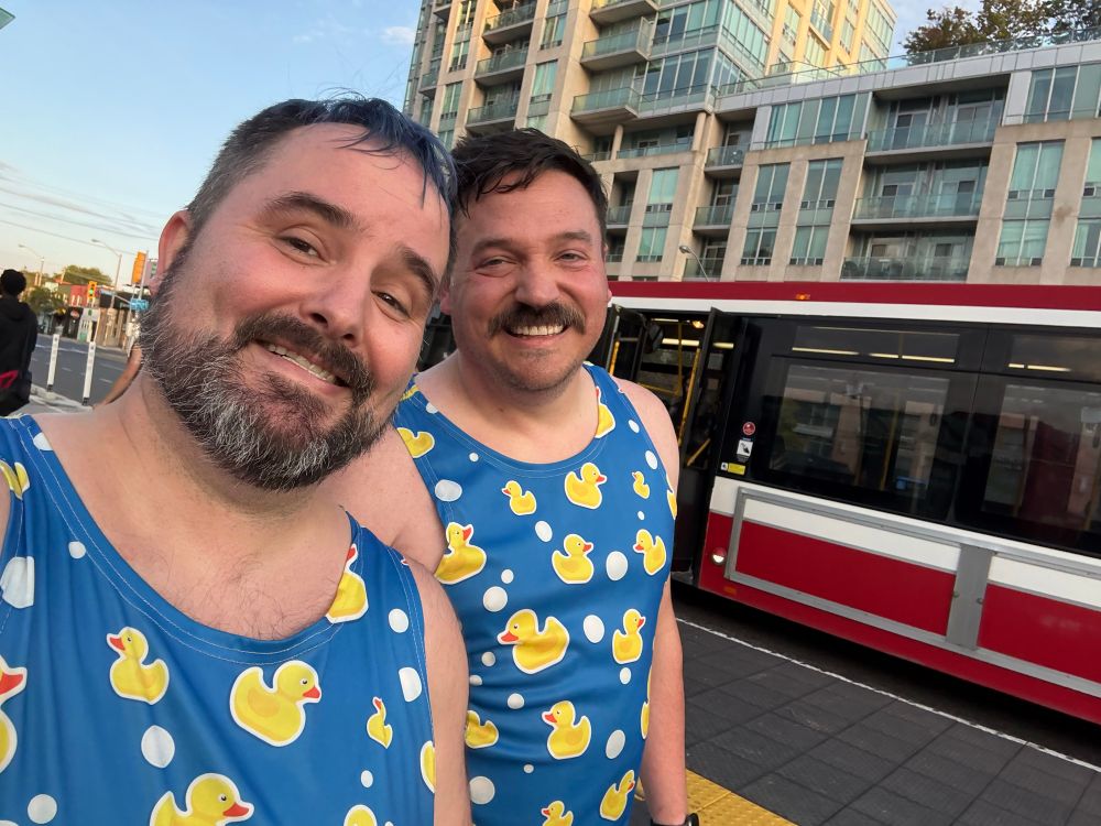 Selfie of myself and my husbeast walking back from CrossFit class.  We are wearing matching blue tank tops with a rubber ducky pattern