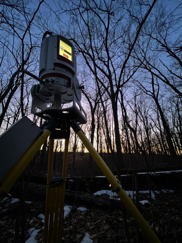 Laser scanner in the forest at sunset