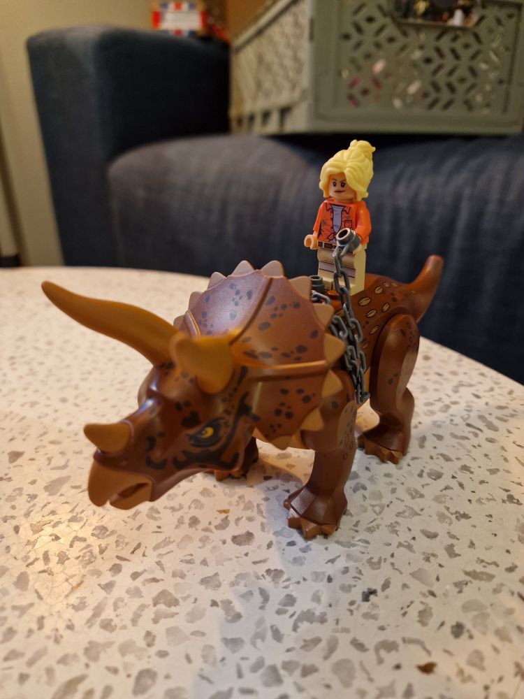 Lego-Ellie Sattler rir på en triceratops 