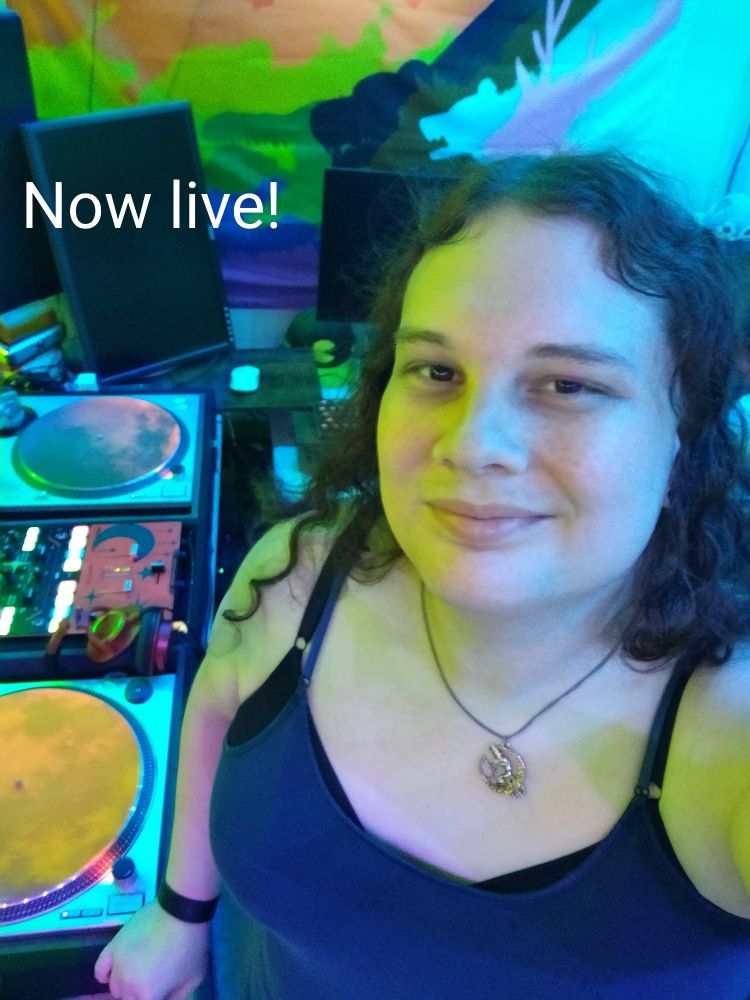Sierra standing in her dj studio with text saying "now live!"