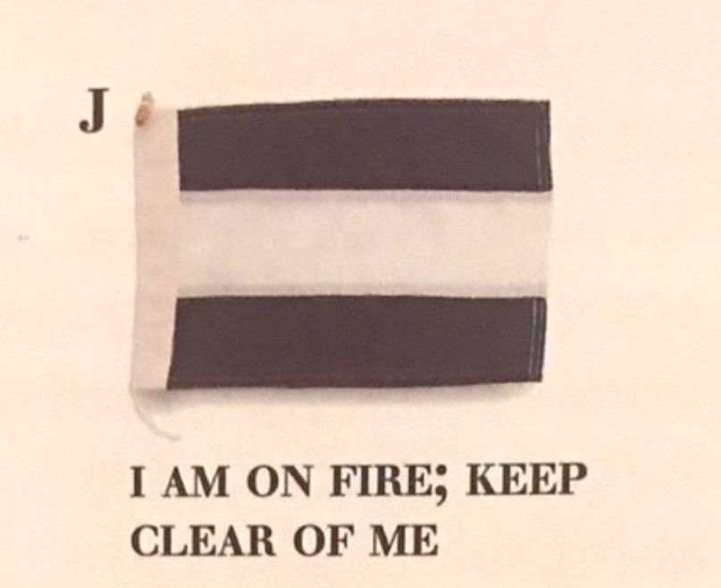Nautical flag, two horizontal black stripes, divided by a horizontal white stripe. Meaning: I am on fire; keep clear of me.