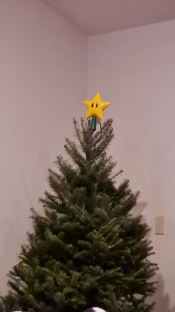 Super Mario star tree topper on a Christmas tree