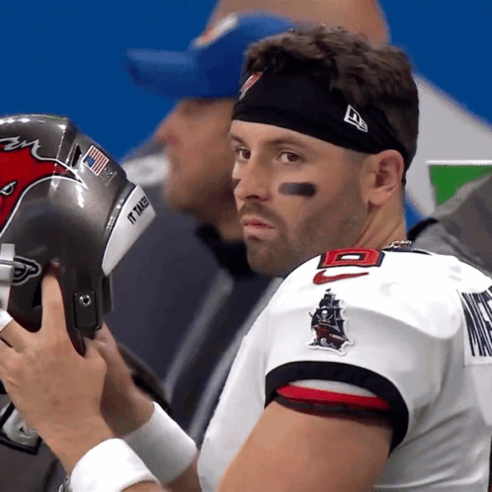 a man wearing a headband that says it takes on it