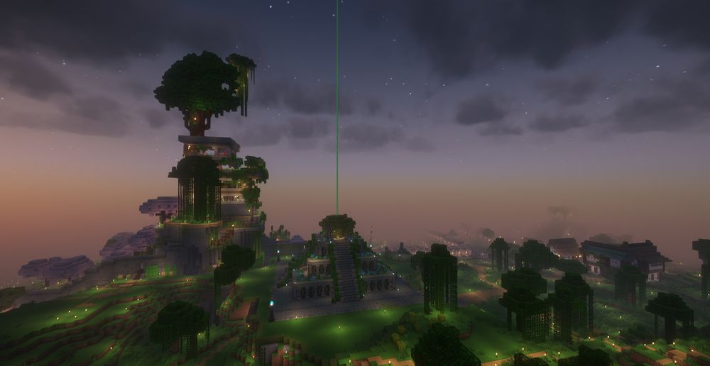 An overhead screenshot of a megabase build rising up out of the darkness of dawn. A large custom tree tops a giant mountain home. Below, an unassuming pyramid structure throws a beacon beam to the sky. In the distance, cherry trees and the beginnings of a town are visible.