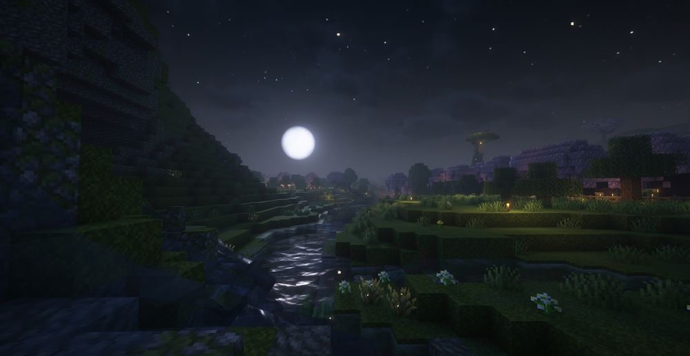 A minecraft screenshot of the overworld. The full moon rises over a small creek, with custom terraforming in the foreground. In the distance, the big old tree of the New Player House is visible. Stars and fireflies make a magical night.